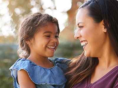 A woman and a child are smiling at the camera.